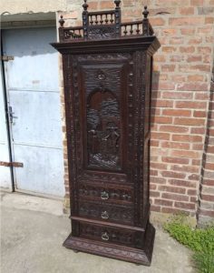 A very nice atypically narrow carved cabinet