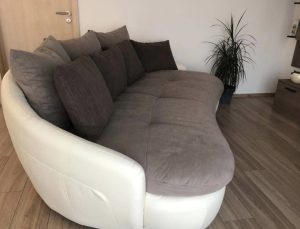 Sofa with pillows and extra pouf